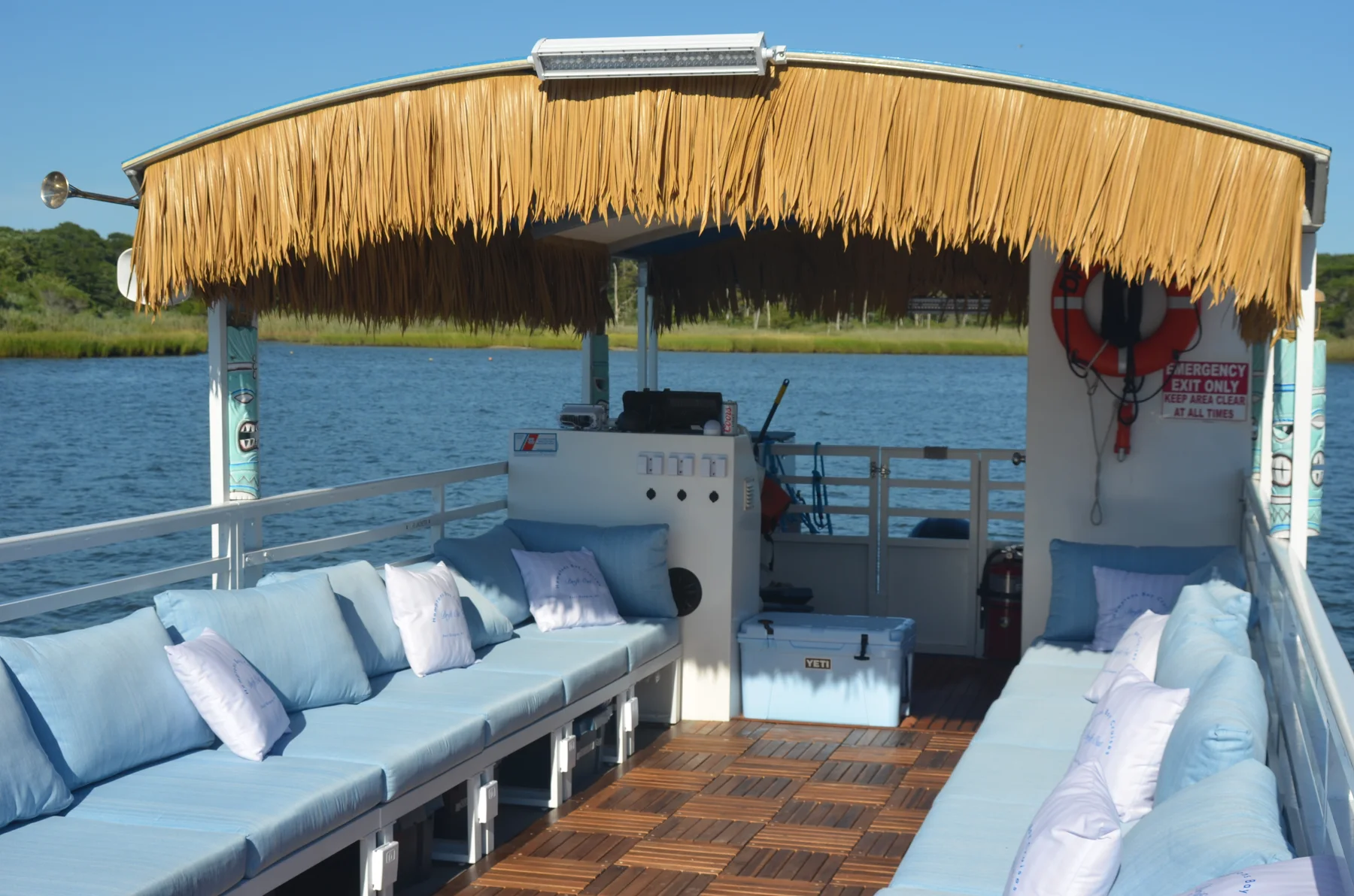 Seating and amenities aboard 35ft Tiki Boat · The Drift Out